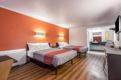 a hotel room with two beds and a desk at Motel 6-Schenectady, NY in Schenectady