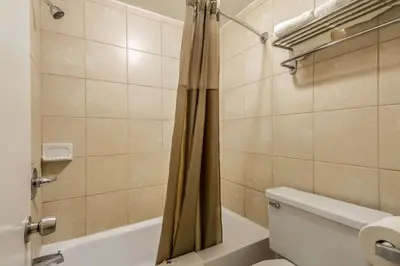 a bathroom with a tub and a toilet and a shower at Motel 6-Schenectady, NY in Schenectady