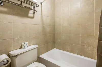 a bathroom with a toilet and a bath tub at Motel 6-Schenectady, NY in Schenectady