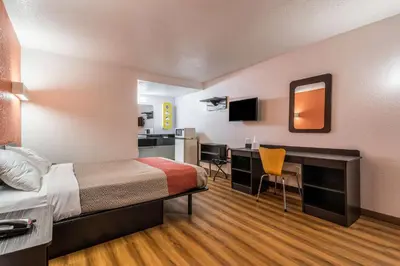 a hotel room with a bed and a desk at Motel 6-Schenectady, NY in Schenectady