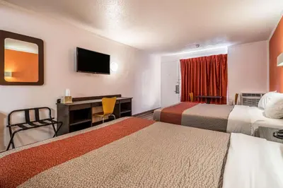 a hotel room with two beds and a desk at Motel 6-Schenectady, NY in Schenectady