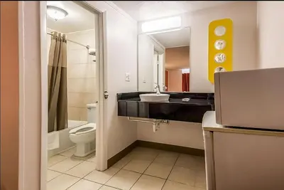 a bathroom with a sink and a toilet and a mirror at Motel 6-Schenectady, NY in Schenectady