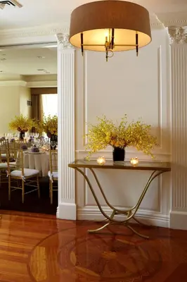 a table with flowers on it in a dining room at Trump International New York in New York