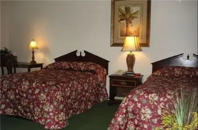 a hotel room with two beds and two lamps at Colonie Inn and Suites in Latham