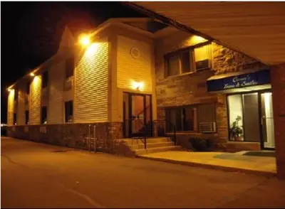 a building with lights on the side of a street at Colonie Inn and Suites in Latham