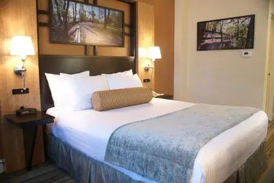 a hotel room with a large bed with white pillows at Best Western Queens Gold Coast in Queens