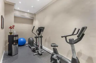 a fitness room with treadmills and exercise bikes at Best Western Queens Gold Coast in Queens