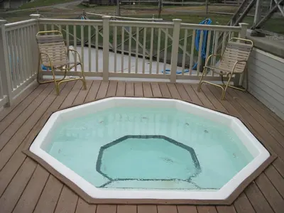 a large swimming pool on a deck with two chairs at Jiminy Peak Mountain Resort in Hancock