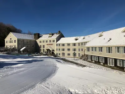 a snow covered street in a town with buildings at Jiminy Peak Mountain Resort in Hancock