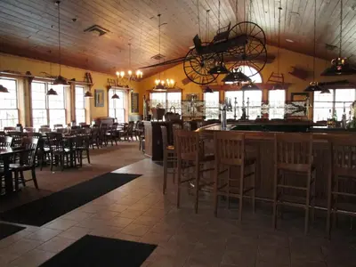 a restaurant with a bar and tables and chairs at Jiminy Peak Mountain Resort in Hancock