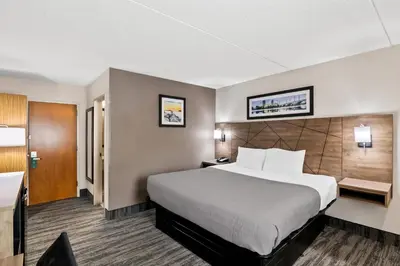 a hotel room with a large bed and a desk at Quality Inn Westfield - Springfield in Westfield