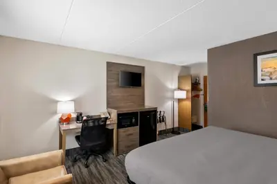 a hotel room with a bed and a desk at Quality Inn Westfield - Springfield in Westfield