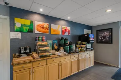 a restaurant with a counter with food on it at Quality Inn Westfield - Springfield in Westfield