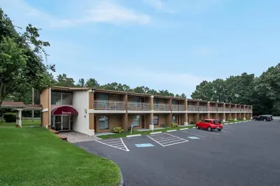 an exterior view of a hotel with a parking lot at Quality Inn Westfield - Springfield in Westfield