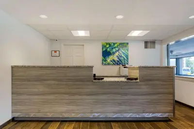 a waiting room with a large wooden wall at Econo Lodge Hicksville - Long Island in Hicksville