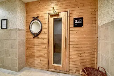 a mirror on a wooden wall in a bathroom at Roosevelt Inn & Suites Saratoga Springs in Saratoga Springs