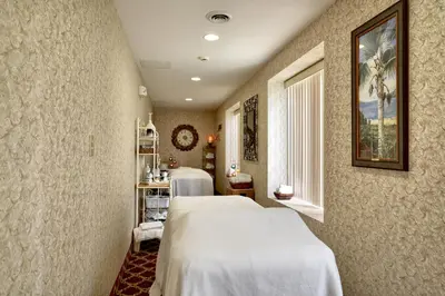 a hospital room with a bed and a window at Roosevelt Inn & Suites Saratoga Springs in Saratoga Springs