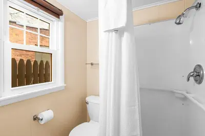 a bathroom with a toilet and a window at Phoenicia Lodge in Phoenicia