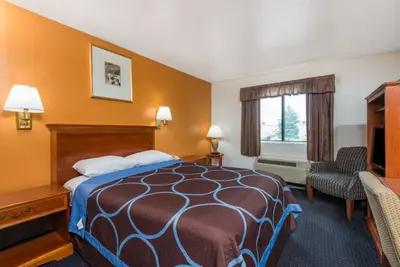a hotel room with a bed and a television at Super 8 by Wyndham Hartford in Hartford