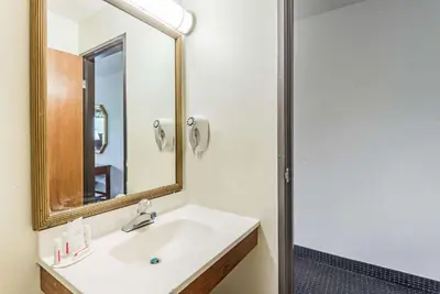 a bathroom with a sink and a mirror at Super 8 by Wyndham Hartford in Hartford