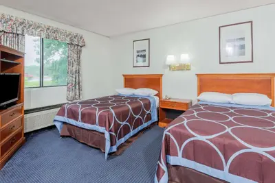 a hotel room with two beds and a flat screen tv at Super 8 by Wyndham Hartford in Hartford