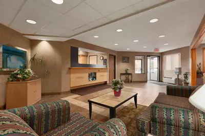 a lobby with couches and a table in a room at Riverdale Inn in Springfield