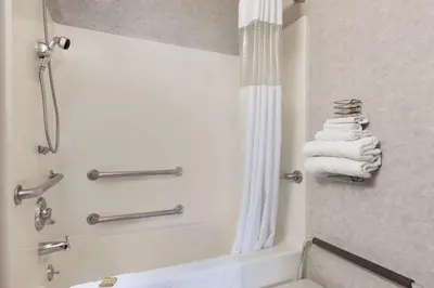 a bathroom with a shower and a tub with towels at Riverdale Inn in Springfield