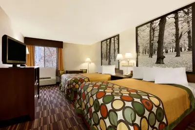 a hotel room with two beds and a flat screen tv at Riverdale Inn in Springfield