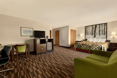 a hotel room with a bed and a desk at Riverdale Inn in Springfield
