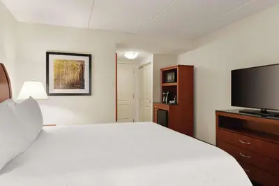a hotel room with a bed and a flat screen tv at Hilton Garden Inn Shelton in Shelton