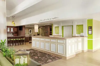 a lobby with a bar in the middle of a building at Hilton Garden Inn Shelton in Shelton