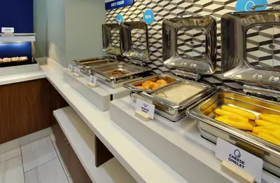 a buffet line with trays of food on display at Holiday Inn Express & Suites Pittsfield-Lenox-Berkshires by IHG in Pittsfield