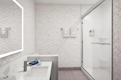 a white bathroom with a shower and a sink at Holiday Inn Express & Suites Pittsfield-Lenox-Berkshires by IHG in Pittsfield