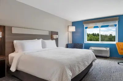 a hotel room with a bed and a window at Holiday Inn Express & Suites Pittsfield-Lenox-Berkshires by IHG in Pittsfield