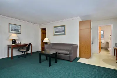 a living room with a couch and a desk at Travelodge by Wyndham Great Barrington Berkshires in Great Barrington