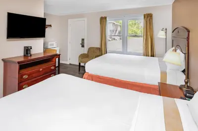 a hotel room with two beds and a television at Travelodge by Wyndham Great Barrington Berkshires in Great Barrington