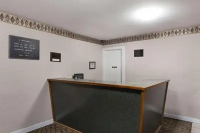 a bar in a room with a sign on the wall at Travelodge by Wyndham Great Barrington Berkshires in Great Barrington