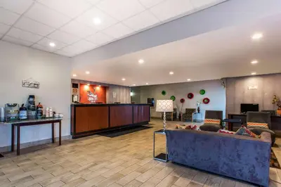 a lobby of a hotel with a couch and a bar at Quality Inn West Springfield in West Springfield