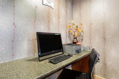 a desk with a computer and a printer on it at Quality Inn West Springfield in West Springfield