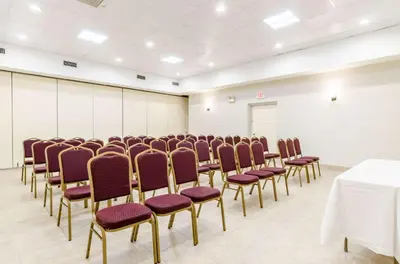 a conference room with rows of chairs and a table at Quality Inn West Springfield in West Springfield