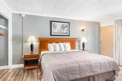 a hotel room with a bed and two lamps at FairBridge Inn and Suites West Point in Highland Falls
