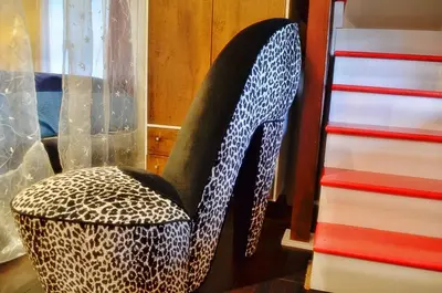 a cheetah print chair sitting next to a dresser at Romantic, Magical Cottage in Catskills nr Woodstock in Willow