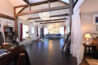 a living room with wooden floors and a ceiling with beams at Romantic, Magical Cottage in Catskills nr Woodstock in Willow