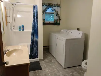 a bathroom with a washing machine and a sink at Mountain Retreat in Wilmington