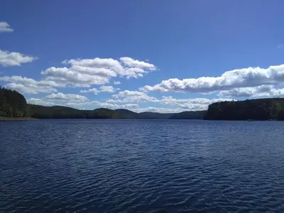 a large body of water with trees in the background at Mountain Retreat in Wilmington
