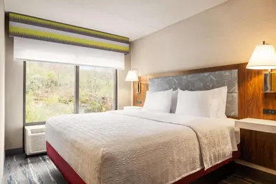 a hotel room with a bed and a window at Hampton by Hilton Shelton in Shelton