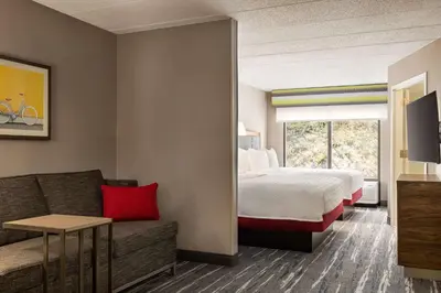 a hotel room with a bed and a couch at Hampton by Hilton Shelton in Shelton