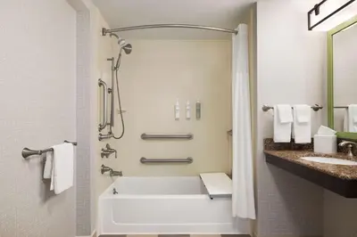 a bathroom with a tub and a sink at Hampton by Hilton Shelton in Shelton
