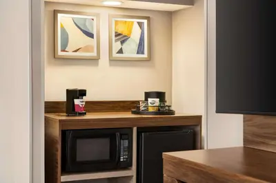 a hotel room with a microwave and a table at Hampton by Hilton Shelton in Shelton