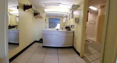 a bathroom with a sink and a bath tub at Newburgh Inn in Newburgh